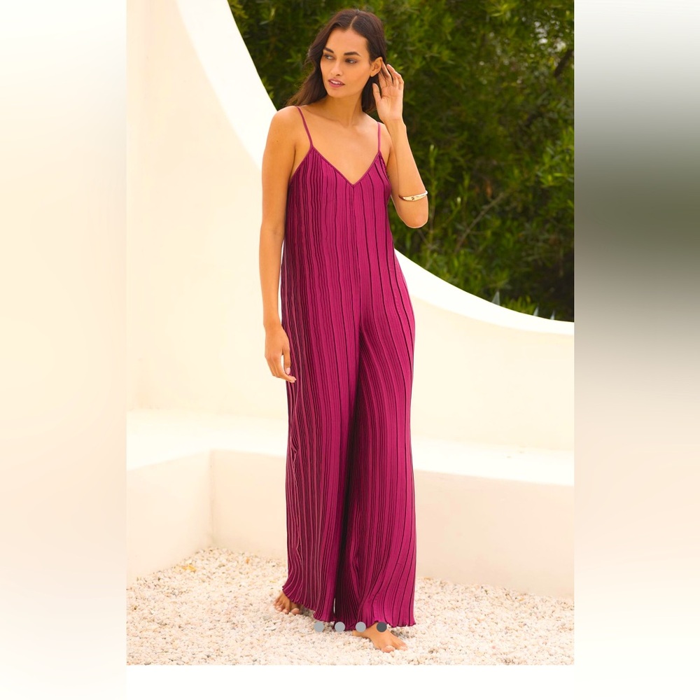 By Anthropologie Sleeveless
Plissé Jumpsuit - color is a vibrant wine